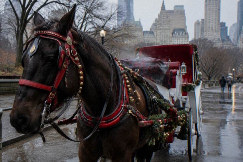 A horse-drawn carriage with holiday lights passing through a festive New York street at night