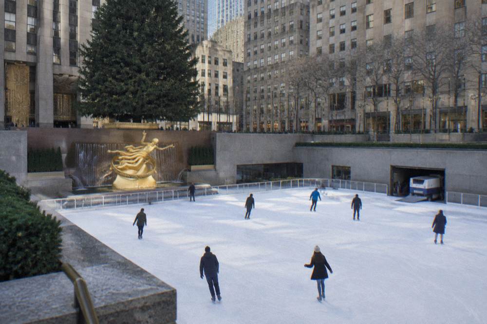 Morning ice rink at Rockefeller Center beneath the Christmas tree and surrounding towers