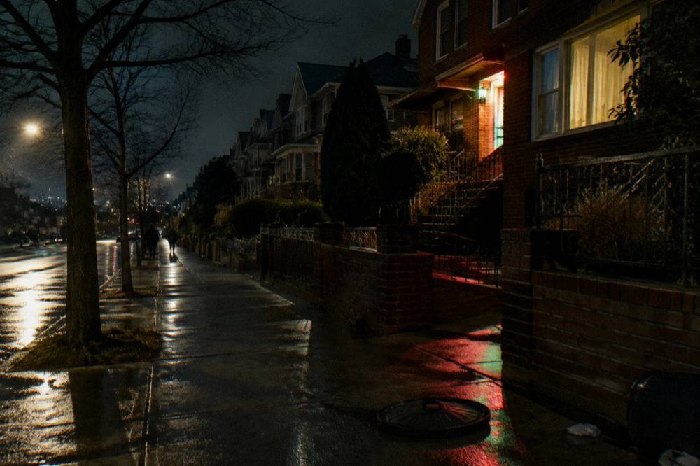 A quiet festive Brooklyn side street at night with holiday lights reflecting on wet pavement