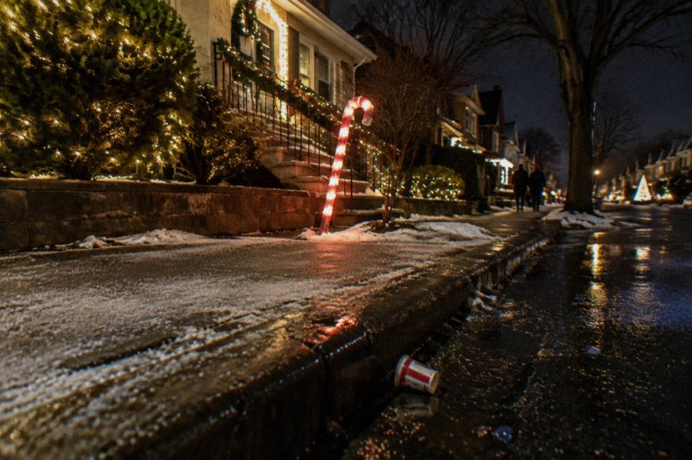 Decorated Brooklyn street corner glowing with string lights at night