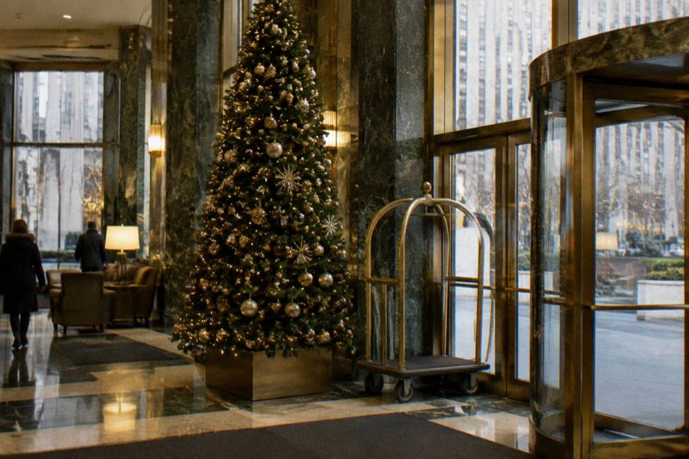 Festive hotel lobby with a decorated Christmas tree and warm lighting